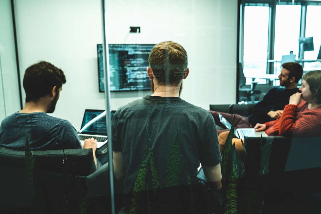 corporate team discussing code