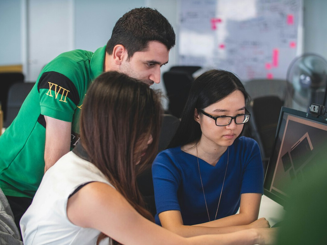 corporate team discussing code